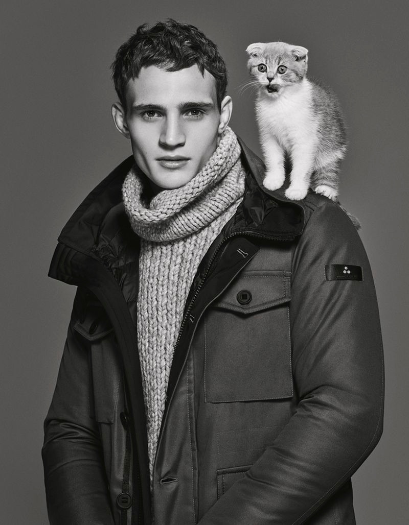 Julian Schneyder poses with a cat for Peuterey's fall-winter 2019 men's campaign.