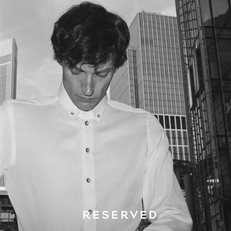 Connecting with Reserved, Thilo Muller dons a classic white shirt.