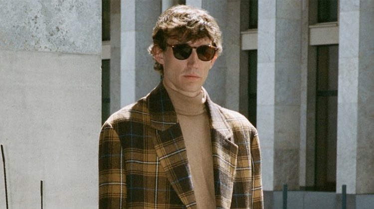 Thilo Muller dons a plaid coat and turtleneck sweater by Reserved.