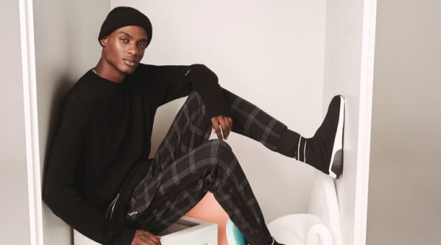 Rachide Embaló Dons Wardrobe Icons for River Island Embracing zipper details, Rachide Embaló rocks a River Island sweater $70.
