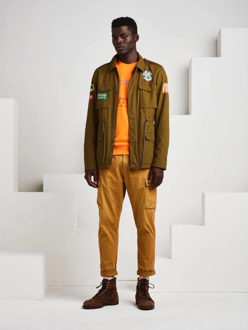 Embracing military style, Evandro Laurens sports a patched jacket with cargo chino pants from Scotch & Soda.