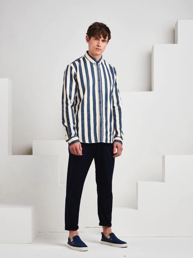 Luc van Geffen sports a striped shirt with chinos and slip-on sneakers for a smart look.