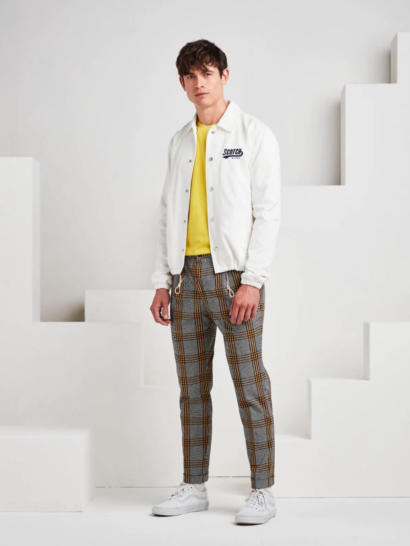 Going sporty, Luc van Geffen wears a Scotch & Soda coach jacket with plaid chinos and white sneakers.