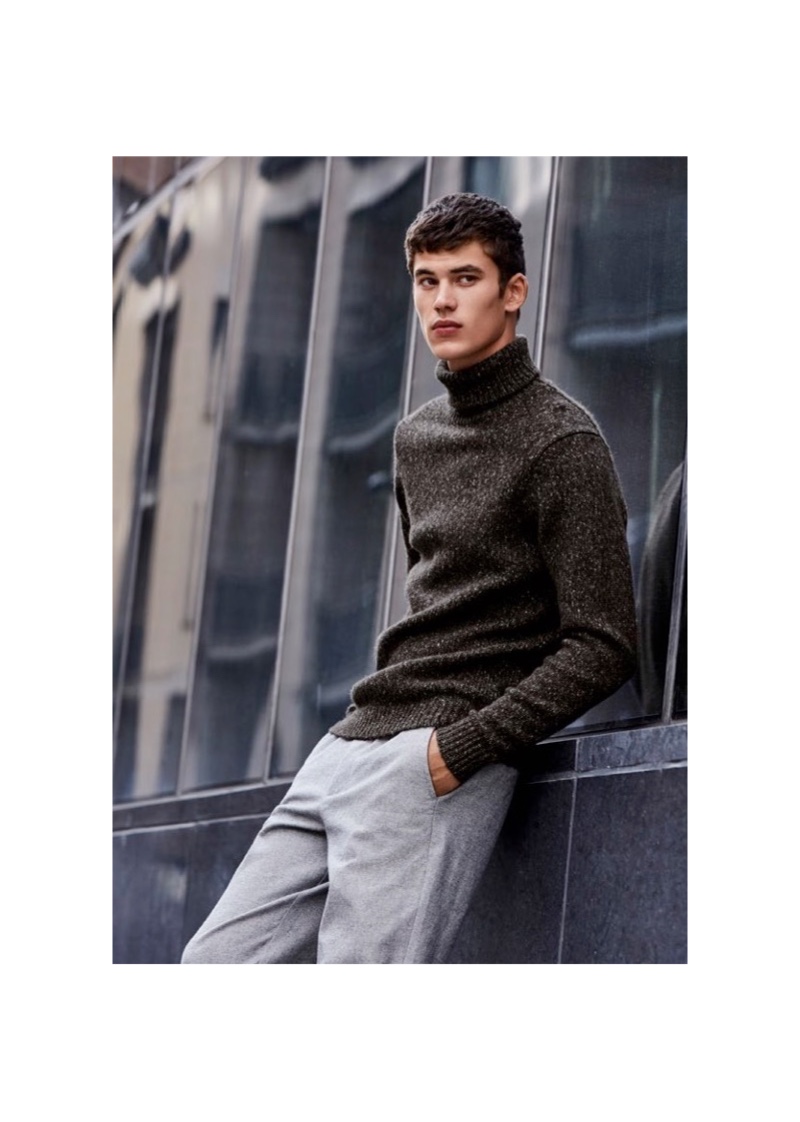 Front and center, Finn Hayton dons a turtleneck sweater and trousers from Simons.