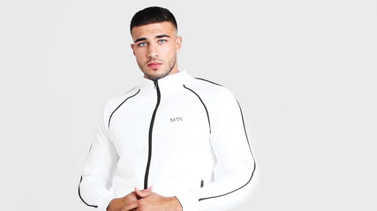 Rocking a white tracksuit, Tommy Fury links up with BOOHOOMAN.