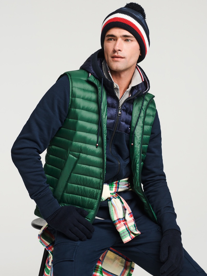 Ready for cold weather, Sean O'Pry wears a quilted vest, zip-up jacket, and more from Tommy Hilfiger.