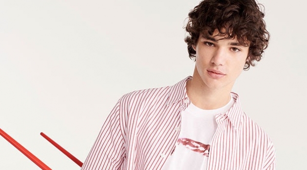 Fernando Lindez Sports Practical Mix & Match Style for YOOX Connecting with YOOX, Fernando Lindez wears a red and white striped shirt with a graphic tee.