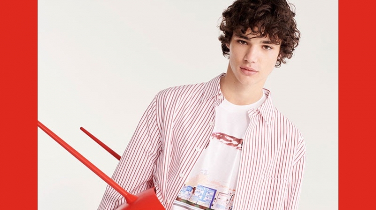 Connecting with YOOX, Fernando Lindez wears a red and white striped shirt with a graphic tee.