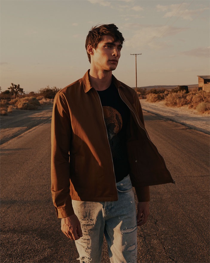 Kian Stevenson sports a textured overshirt with a graphic t-shirt and ripped skinny jeans from Zara.