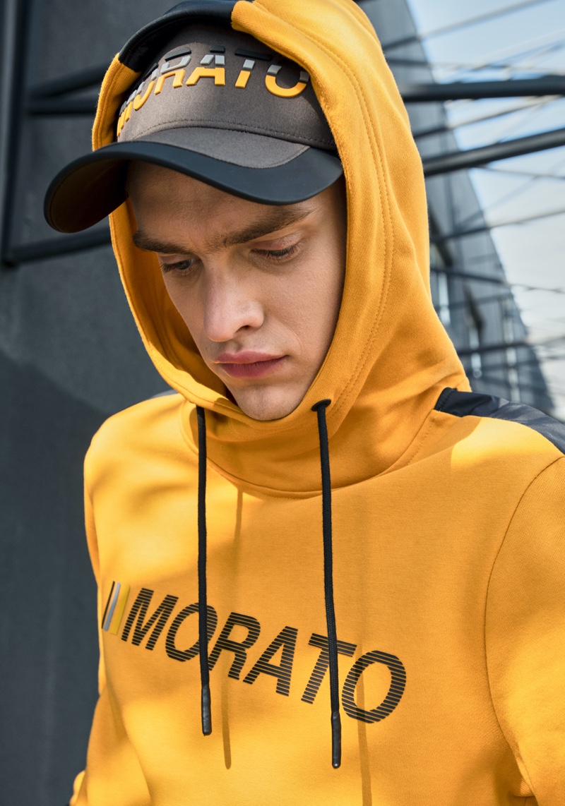 Sporting a yellow hoodie, Simon Kuzmickas connects with Antony Morato for fall-winter 2019.