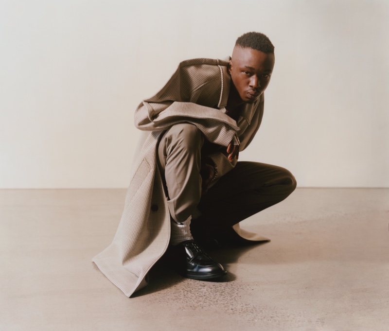 Connecting with MatchesFashion, Ashton Sanders rocks a Maison Margiela coat and trousers with Bottega Veneta shoes.