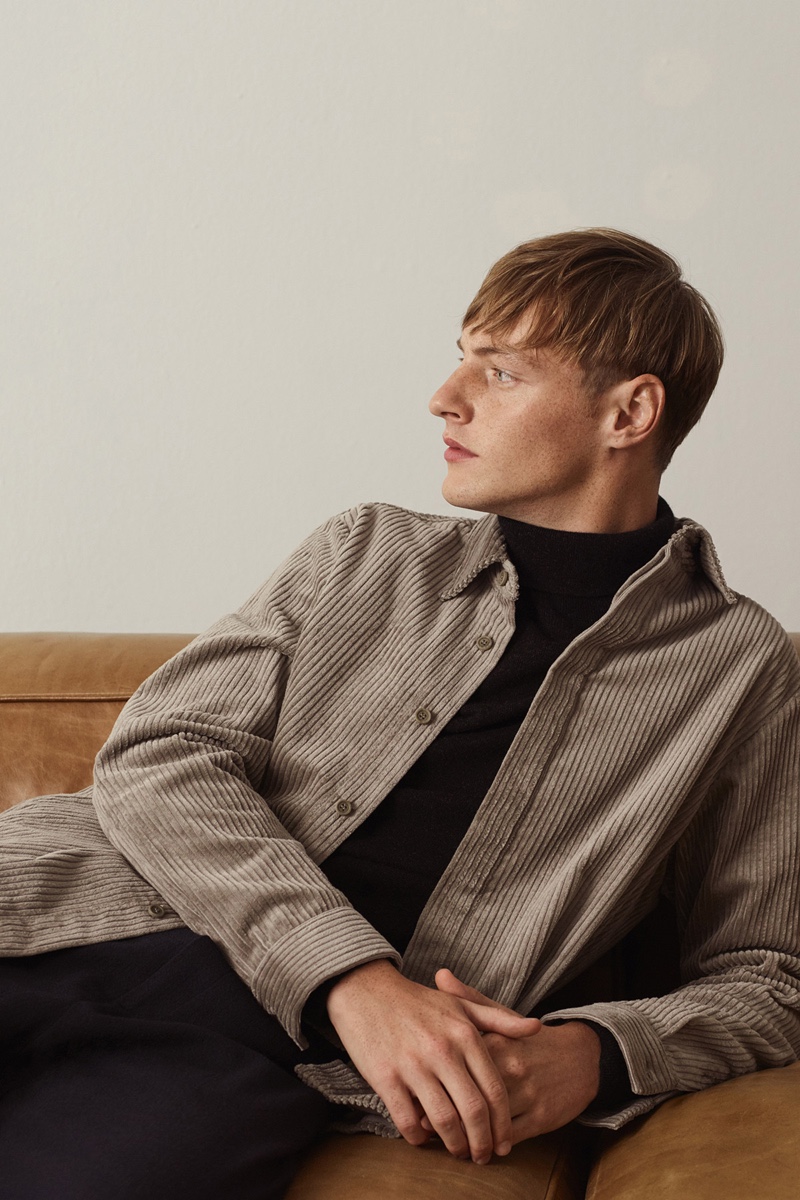 Model Roberto Sipos wears a corduroy overshirt with a turtleneck sweater from COS.