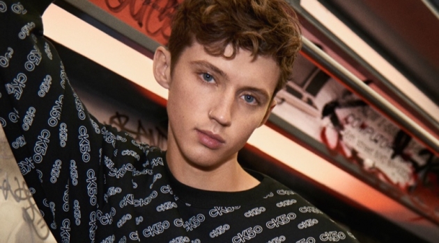 Troye Sivan sports an all-over print look from Calvin Klein's CK50 capsule collection for the brand's new campaign.
