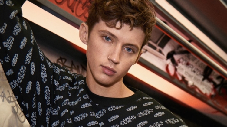 Troye Sivan sports an all-over print look from Calvin Klein's CK50 capsule collection for the brand's new campaign.