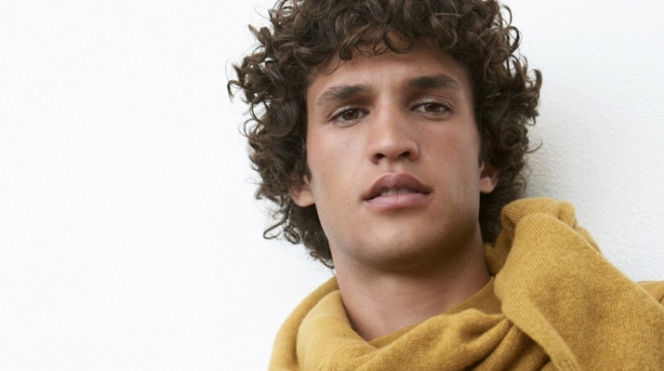 A chic vision, Francisco Henriques dons a gold long-sleeve mockneck tee $79.50 from Club Monaco.