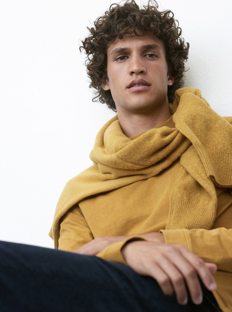 A chic vision, Francisco Henriques dons a gold long-sleeve mockneck tee $79.50 from Club Monaco.