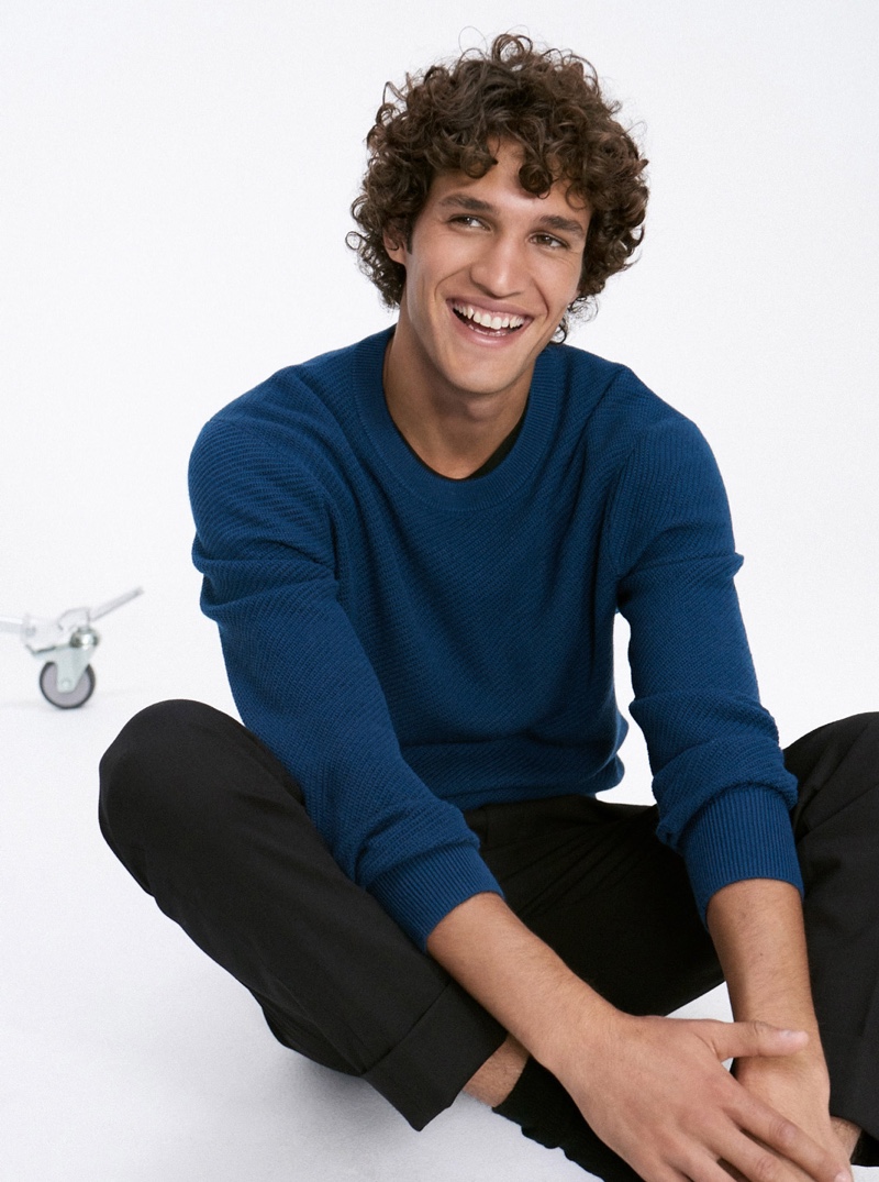 Connecting with Club Monaco, Francisco Henriques models a blue texture twill sweater $139.50.