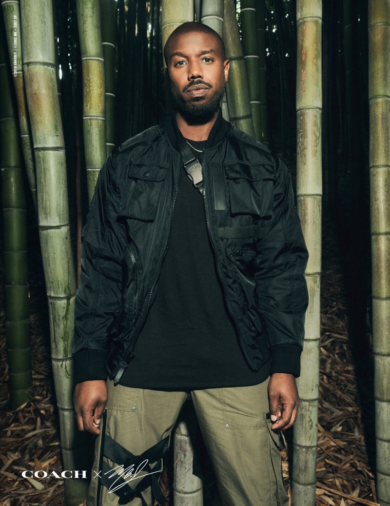 Front and center, Michael B. Jordan rocks a jacket and pants from his Coach capsule collection.