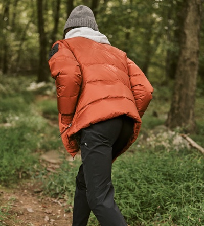 Seth Hill wears a Moose Knuckles puffer jacket with a Barbour knit beanie. He also sports a hoodie and pants by Reigning Champ.