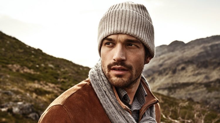 Model Paul Kelly wears a matching knit beanie and scarf from Eton's fall-winter 2019 collection.