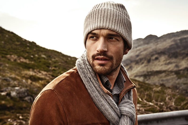 Model Paul Kelly wears a matching knit beanie and scarf from Eton's fall-winter 2019 collection.