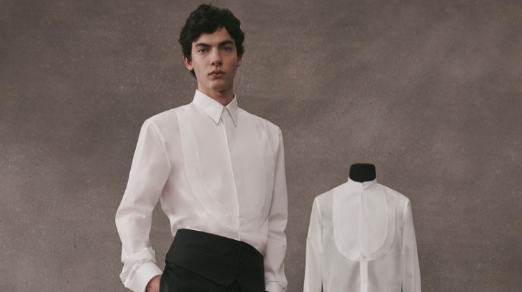 Lev Uliesov dons a sleek white and black tailored look from the Givenchy Atelier collection.
