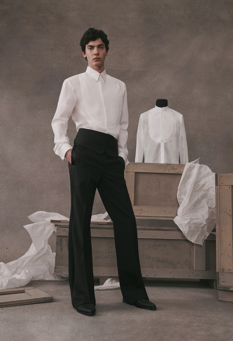 Lev Uliesov dons a sleek white and black tailored look from the Givenchy Atelier collection.