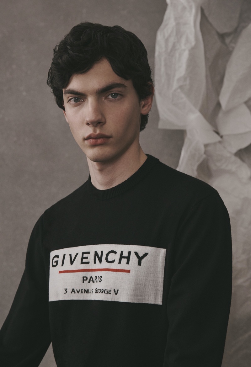 Front and center, Lev Uliesov sports a logo sweater from the Givenchy Atelier collection.