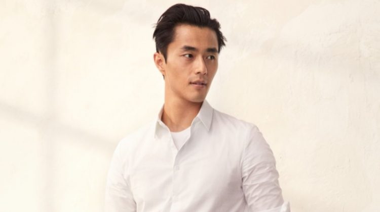 Zhao Lei sports a smart pair of black trousers with a white dress shirt by H&M.