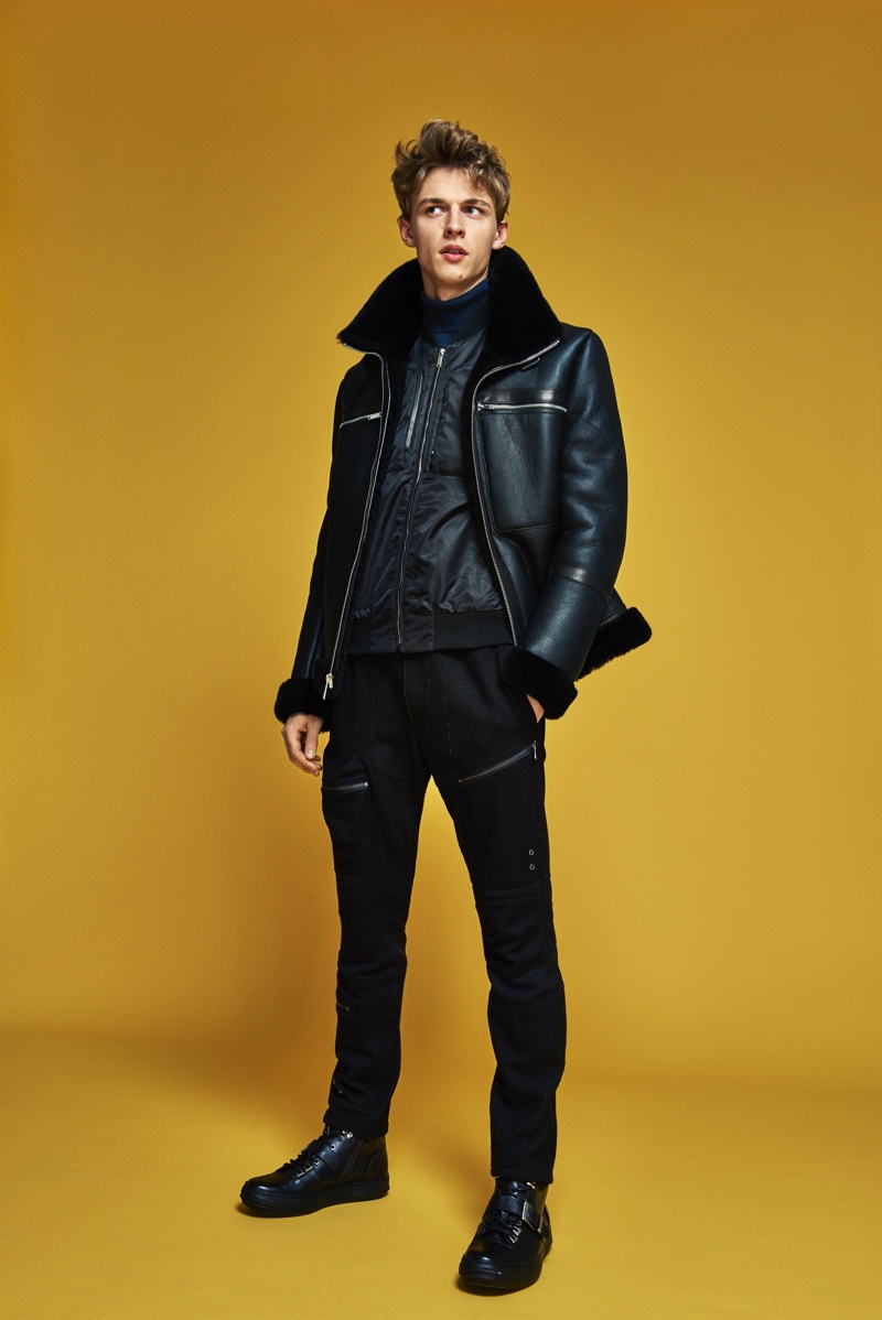 Front and center, Max Barczak dons a sleek black look from Karl Lagerfeld's fall-winter 2019 collection.