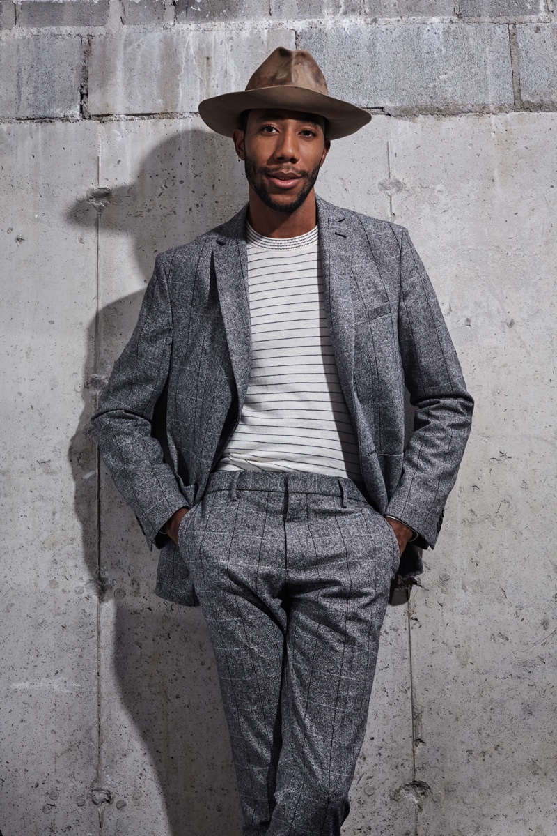 Linking up with Ben Sherman, La Touché dons a sharp windowpane suit in grey with a striped top.