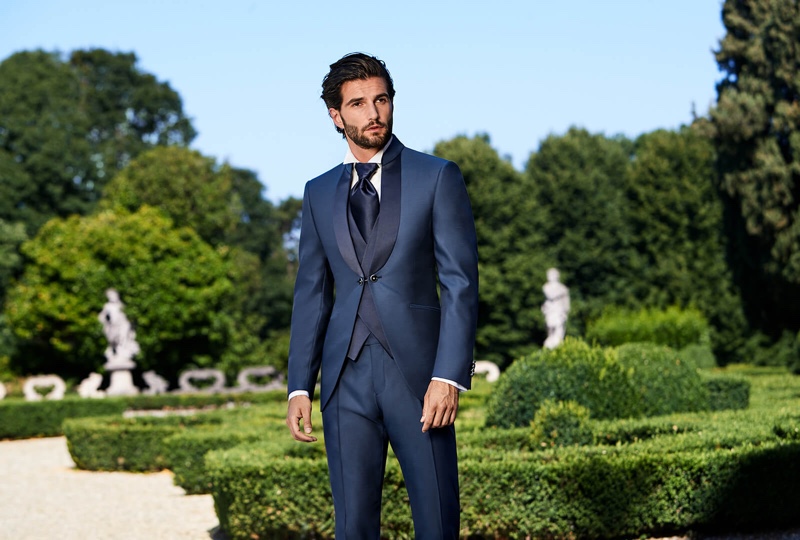 Donning a navy vest and tuxedo, Andrea Melchiorre wears Lubiam 1911 Cerimonia.