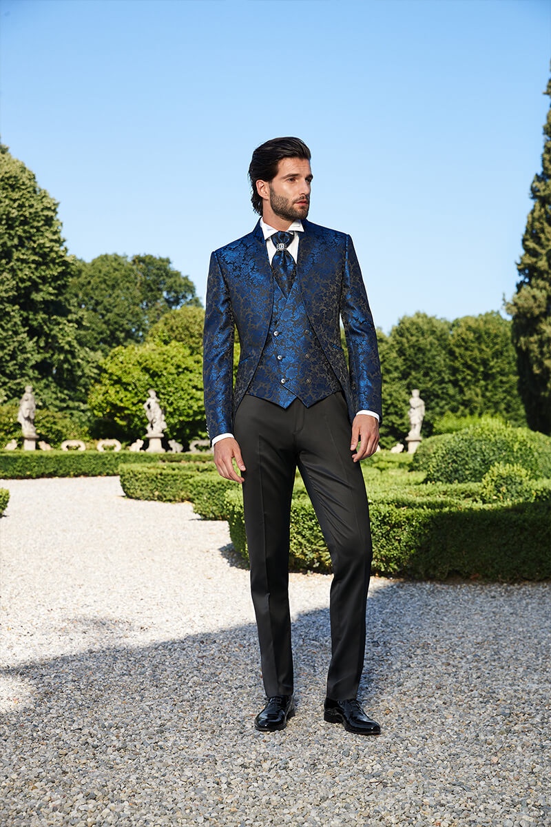 Embracing a dandy flair, Andrea Melchiorre dons a brocade print waistcoat and dinner jacket by Lubiam 1911 Cerimonia.