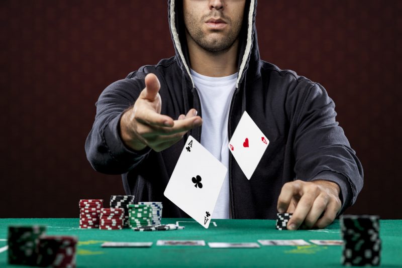 Man Playing Poker in Hoodie