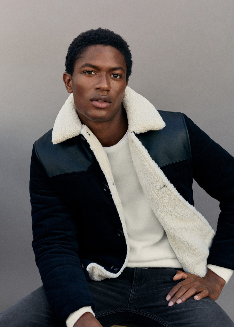 Hamid Onifade sports a corduroy jacket with dark wash jeans from Mango.