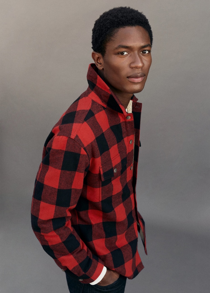 Making a case for black and red, Hamid Onifade wears a classic buffalo check overshirt.