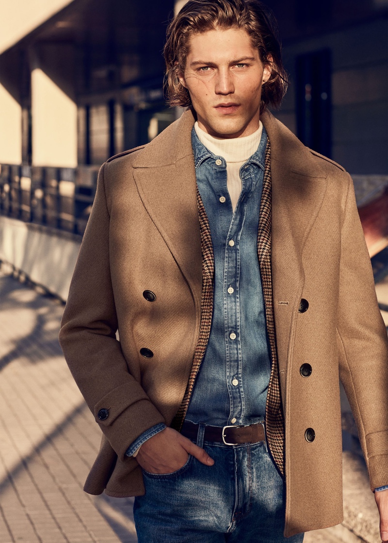 Front and center, Boyd Gates dons a camel coat with double denim from Mango.