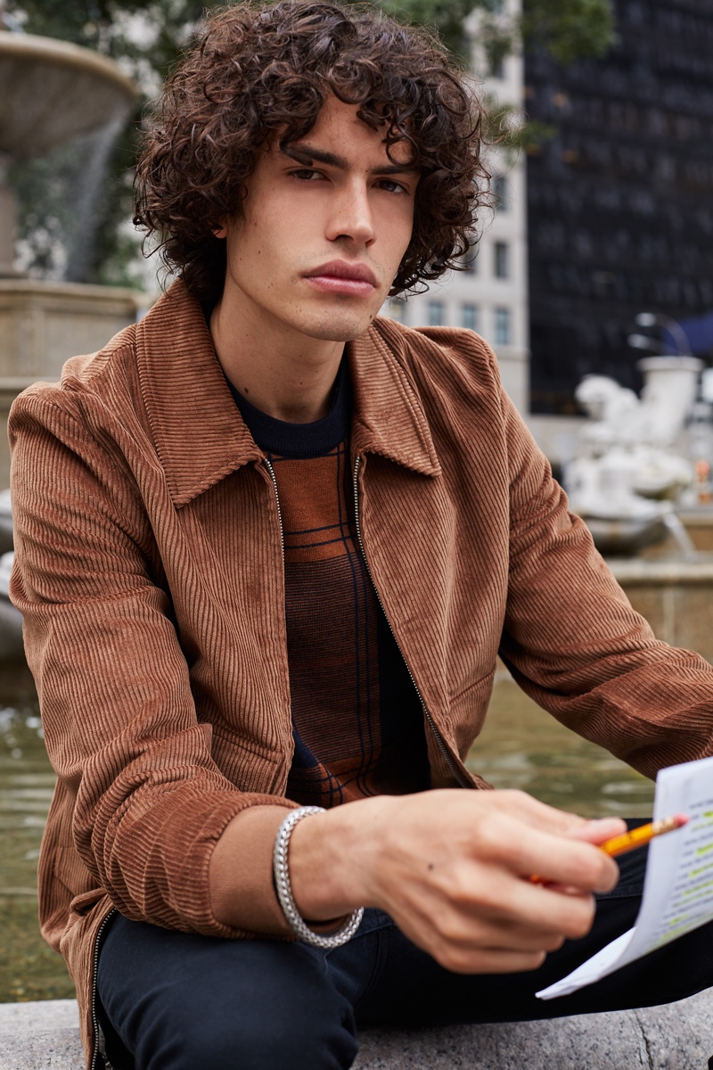 Front and center, Michael Cortina wears a brown corduroy jacket with a graphic top by Ben Sherman.