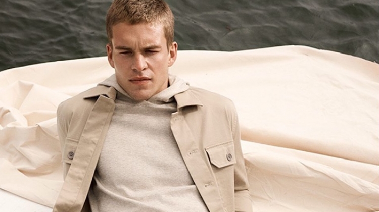Mitchell Slaggert dons a khaki jacket and hoodie with jeans from Banana Republic.