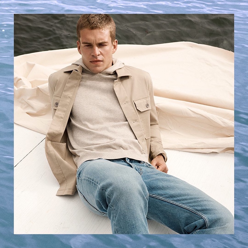 Mitchell Slaggert dons a khaki jacket and hoodie with jeans from Banana Republic.