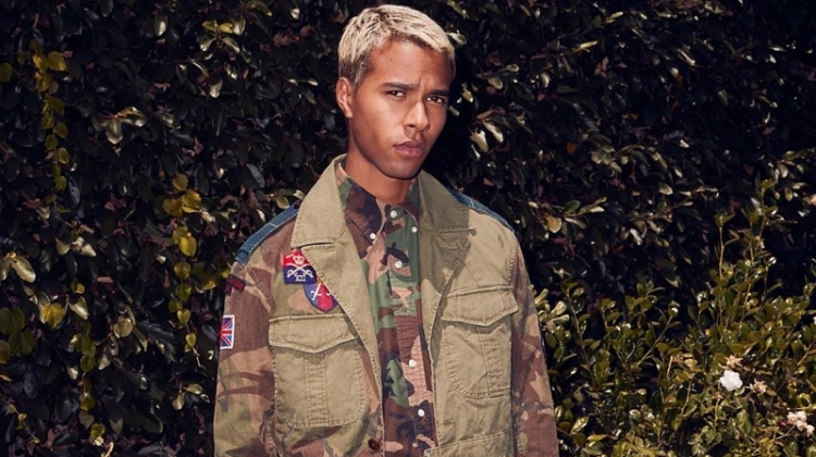 Embracing camouflage prints, Daouda Ka wears a POLO Ralph Lauren oxford shirt $98, hybrid jacket $498, and pants $188.