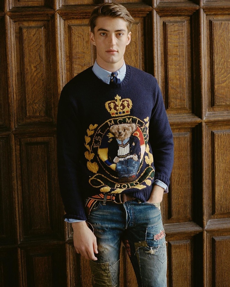 Model Angus Eaton charms in a teddy bear sweater with ripped jeans by POLO Ralph Lauren.