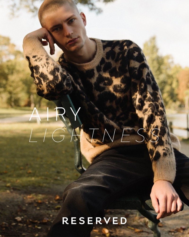 Lucas Berny sports a leopard print sweater from Reserved.