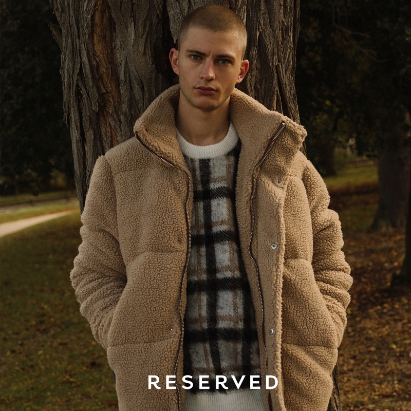 Linking up with Reserved for fall, Lucas Berny sports a fleece jacket with a plaid sweater.
