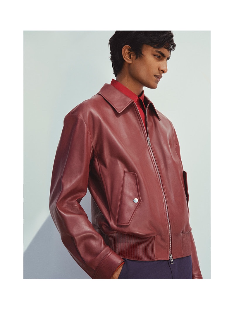 Making a color statement, Rishi Robin dons a red leather jacket by Alexander McQueen.