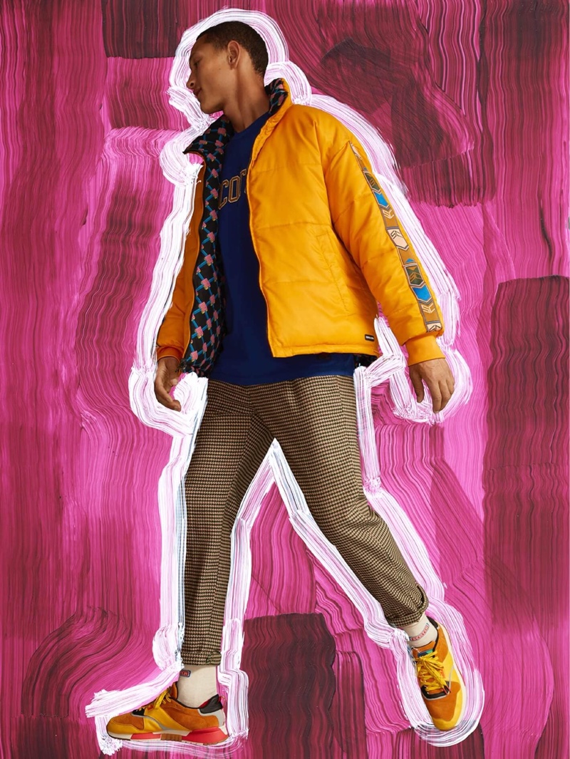 Embracing vibrant colors, Bruno Sitton rocks a Scotch & Soda reversible puffer jacket $275 in yellow.