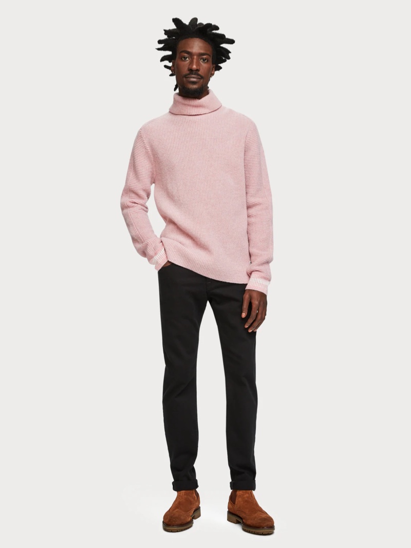 An unusual pink-hued wool-cashmere blend pullover teamed with black jeans for a smart/casual urban look. 