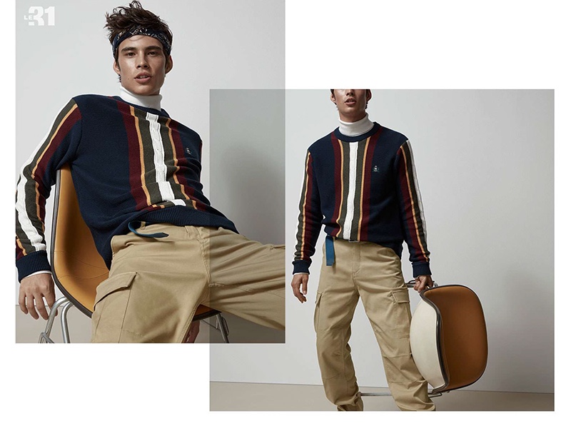 Front and center, Louis Baines sports a LE 31 block striped sweater, turtleneck, cargo pants, and bandana.