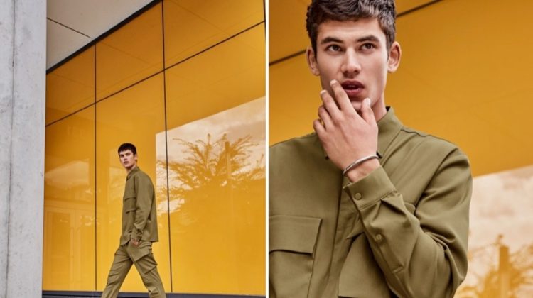 Embracing a neutral color palette, Finn Hayton models a minimalist utilitarian shirt and modern cargo pants from LE 31.