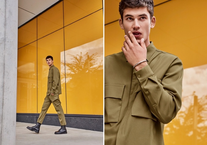 Embracing a neutral color palette, Finn Hayton models a minimalist utilitarian shirt and modern cargo pants from LE 31.